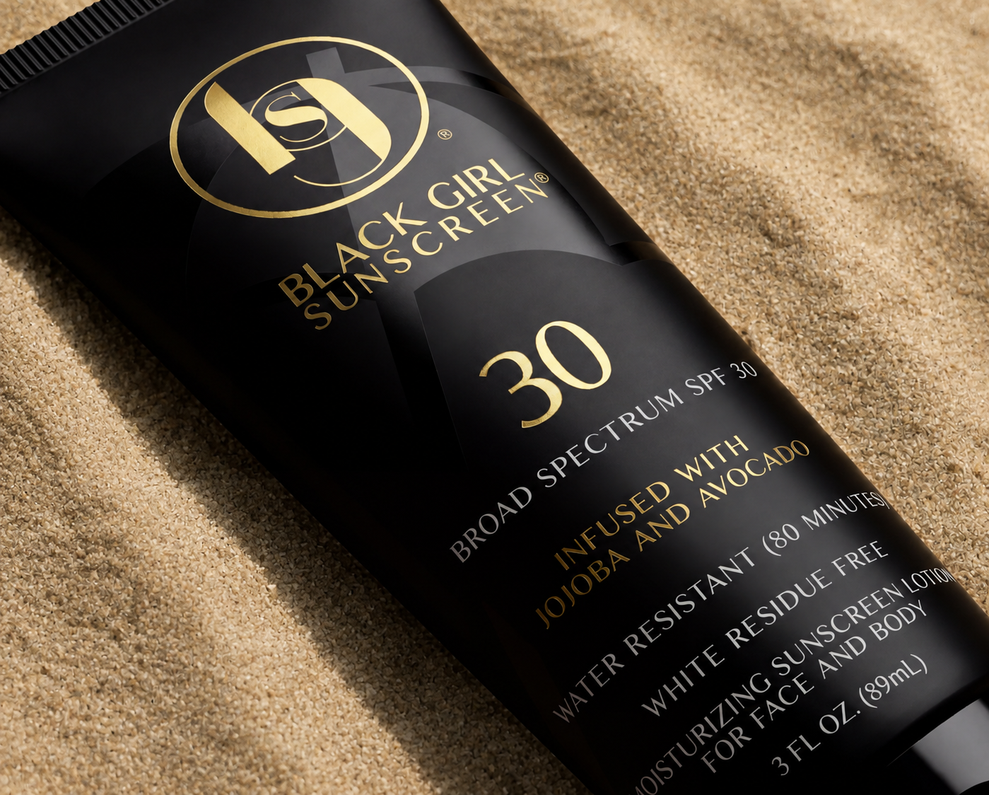 Black Girl Sunscreen SPF 30 tube packaging on sand
